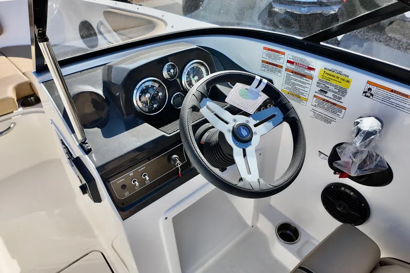 Slide: The Image of 2025 Bayliner VR4 Bowrider OB dashboard with steering wheel and control panel. - 5