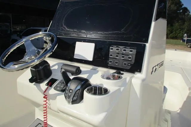 Slide: The Image of 2026 Skeeter SX2350 boat console with steering wheel and control panel. - 13