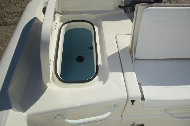 Slide: The Image of 2026 Skeeter SX2350 boat with open storage compartment and seating area. - 5
