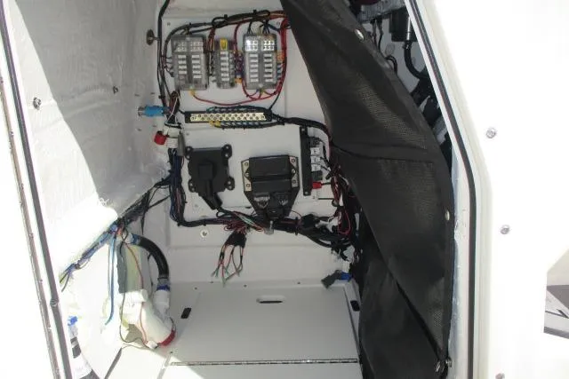 Slide: The Image of Electrical compartment of 2026 Skeeter SX2350 boat, showcasing wiring and components. - 9