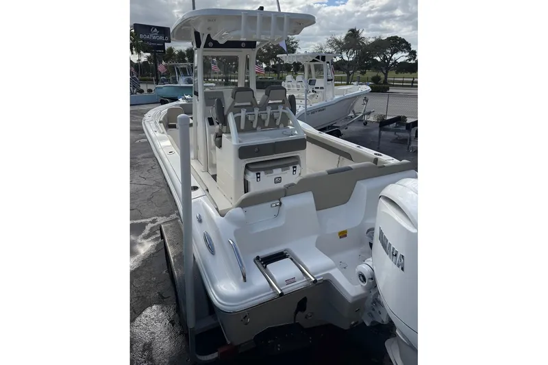 Slide: The Image of 2026 Key West 239 FSR boat with Yamaha engine, parked at a dealership. - 11