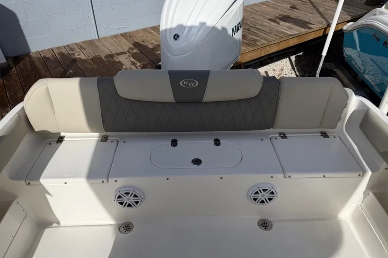 Slide: The Image of 2026 Key West 239 FSR boat interior with cushioned seating and storage compartments. - 14