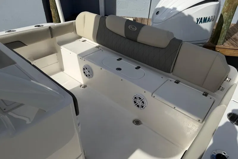Slide: The Image of 2026 Key West 239 FSR boat interior with cushioned seating and storage compartments. - 16