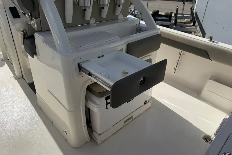 Slide: The Image of 2026 Key West 239 FSR boat interior with open storage compartment and seating area. - 20