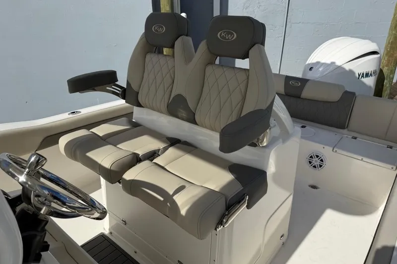 Slide: The Image of 2026 Key West 239 FSR boat interior with dual seats and steering wheel. - 23