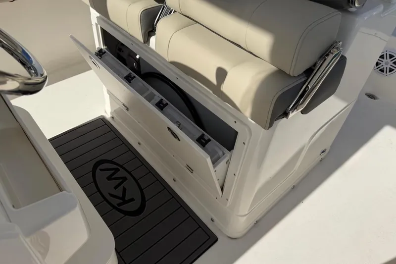 Slide: The Image of 2026 Key West 239 FSR boat interior with storage compartment and cushioned seating. - 25