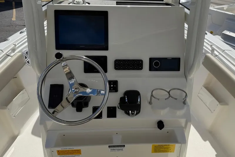 Slide: The Image of Helm of 2026 Key West 239 FSR boat with steering wheel and control panel. - 28
