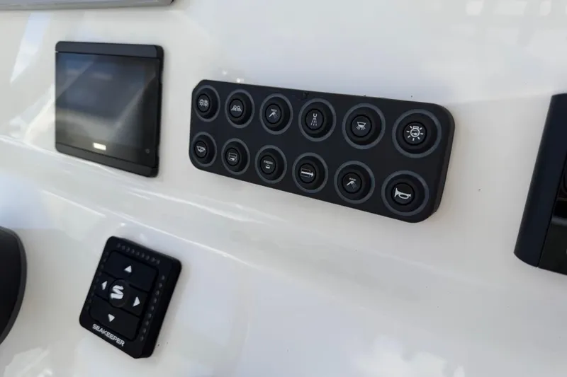 Slide: The Image of Control panel of 2026 Key West 239 FSR boat with various buttons and display. - 30