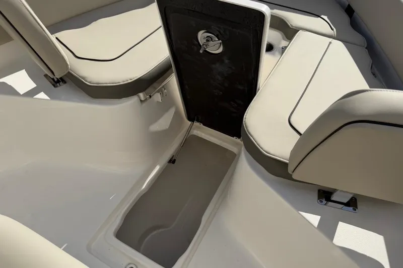 Slide: The Image of 2026 Key West 239 FSR boat interior with open storage compartment and cushioned seating. - 38