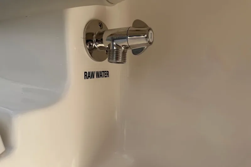 Slide: The Image of Raw water outlet on 2026 Key West 239 FSR boat, featuring chrome finish. - 49