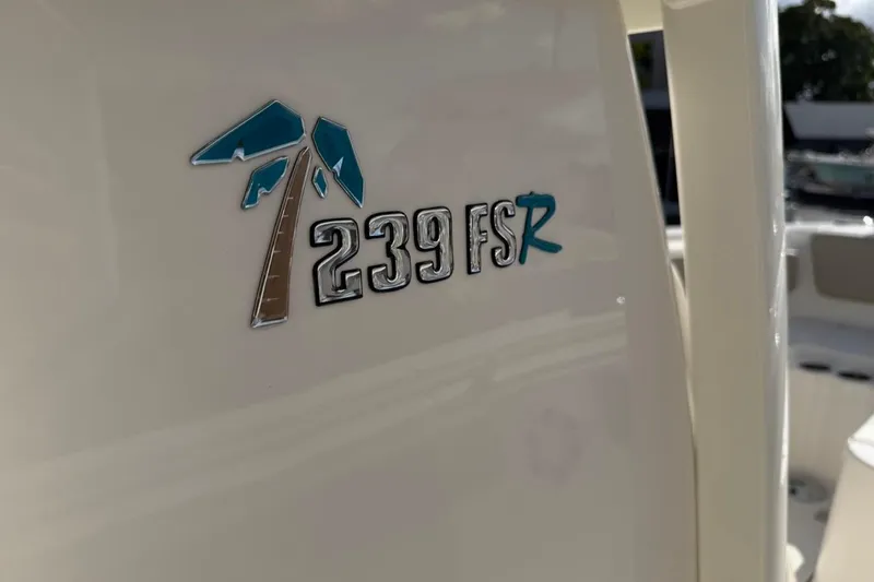Slide: The Image of Key West 239 FSR 2026 boat logo with palm tree design. - 56
