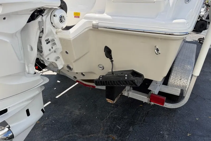 Slide: The Image of 2026 Key West 239 FSR boat on trailer, rear view showing motor and hull details. - 9