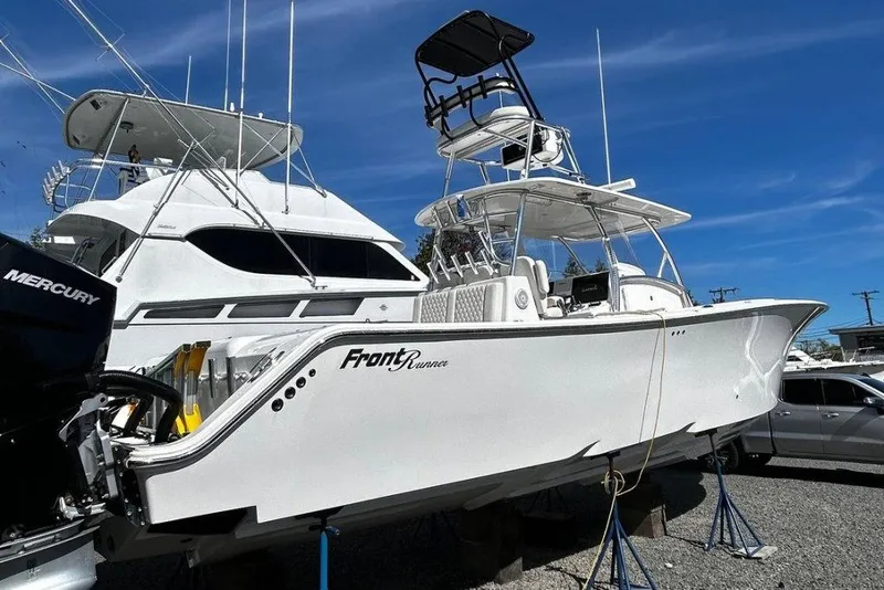 Slide: The Image of 2023 Front Runner 39 Center Console boat on display, featuring sleek design and Mercury engines. - 1