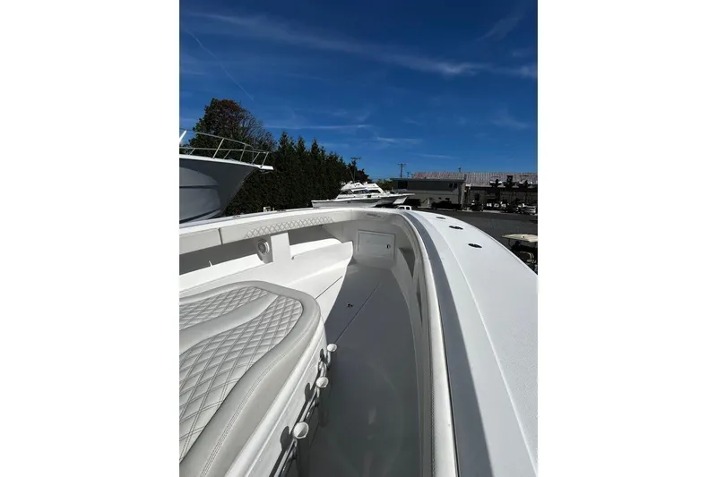 Slide: The Image of 2023 Front Runner 39 Center Console boat, sleek design, white interior, clear blue sky. - 6