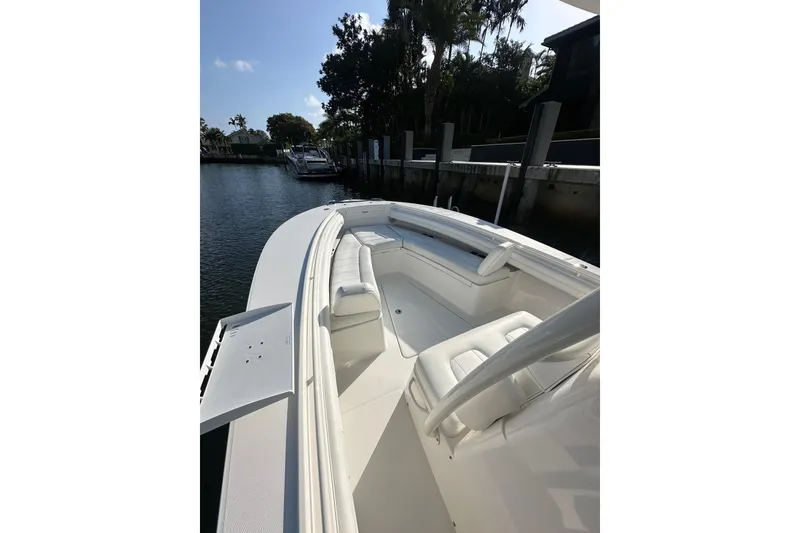 Slide: The Image of 2017 Regulator 28 boat docked, featuring spacious seating and sleek design. - 2