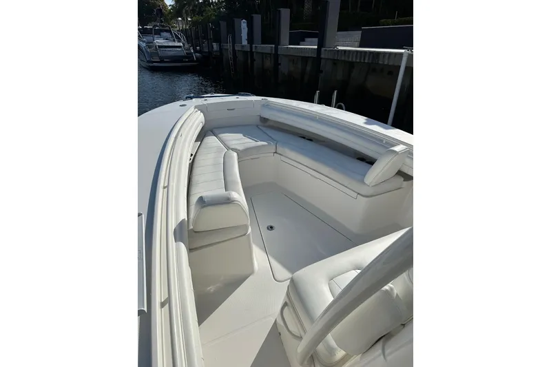 Slide: The Image of 2017 Regulator 28 boat with white seating, docked in a marina. - 3