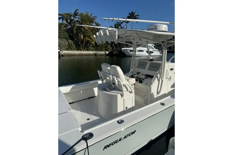 Slide: The Image of 2017 Regulator 28 boat with dual seats and Garmin electronics, docked by a canal. - 5