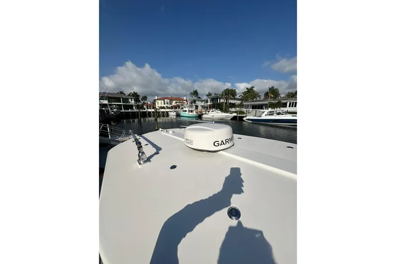 Slide: The Image of 2017 Regulator 28 boat with Garmin radar, docked in a scenic marina. - 6