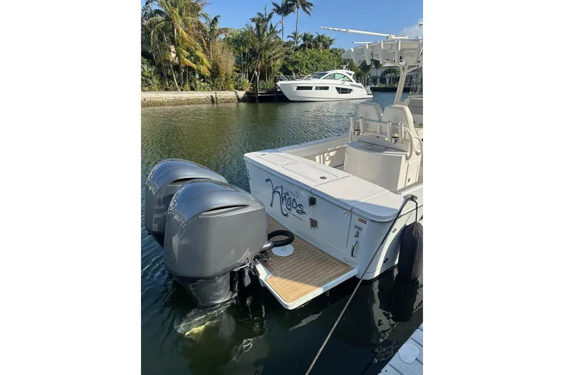 Slide: The Image of 2017 Regulator 28 boat with dual outboard motors docked in a scenic marina. - 8