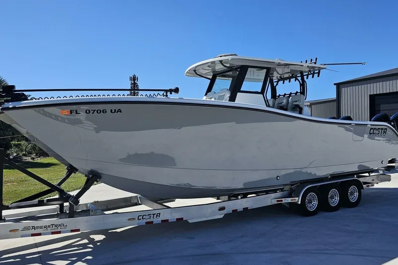 The Image of 2025 Costa Custom Boats 34ST on trailer, sleek design, parked outdoors. - 1