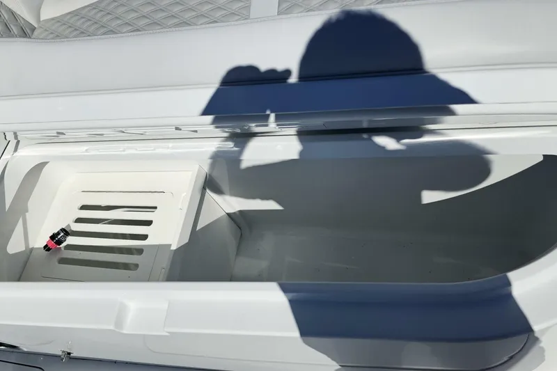Slide: The Image of Open storage compartment on 2025 Costa Custom Boats 34ST, with shadow and small object inside. - 14