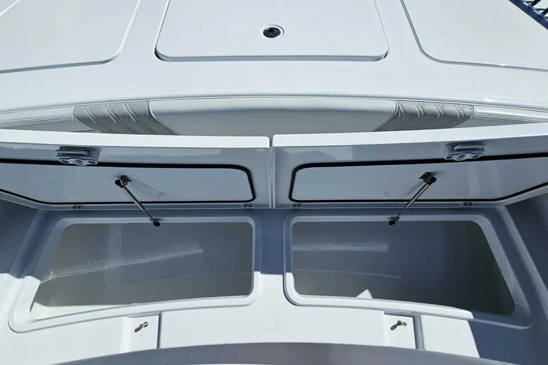 Slide: The Image of 2025 Costa Custom Boats 34ST storage compartments open, showcasing spacious interior design. - 17