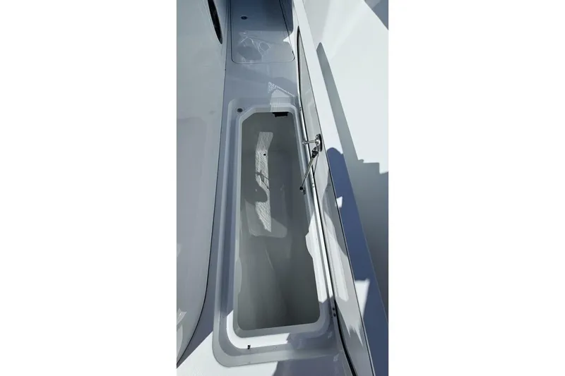 Slide: The Image of 2025 Costa Custom Boats 34ST storage compartment, open and empty, showcasing sleek design. - 21