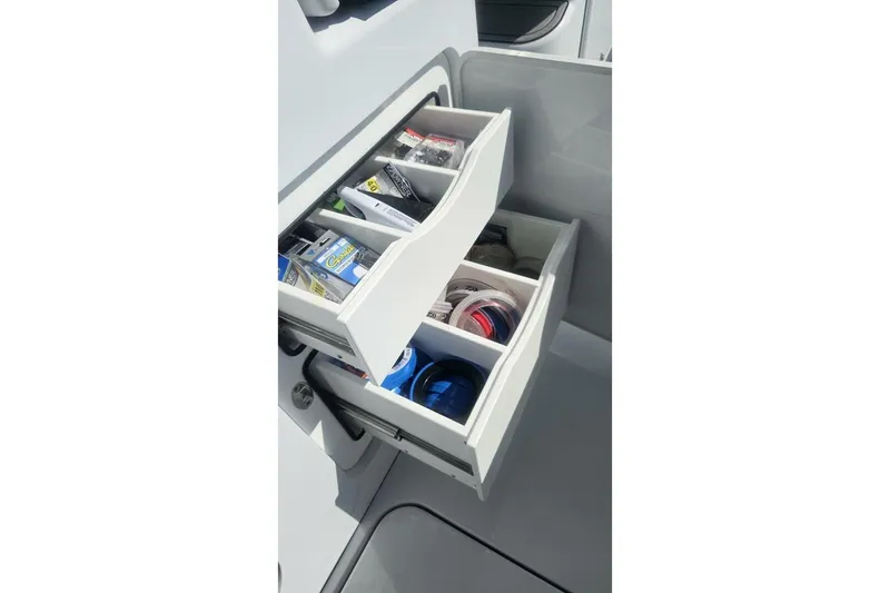 Slide: The Image of Storage drawers on 2025 Costa Custom Boats 34ST, organized with fishing gear and accessories. - 26
