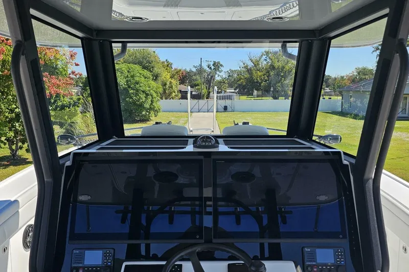Slide: The Image of Interior view of 2025 Costa Custom Boats 34ST cockpit with dual screens and steering wheel. - 28
