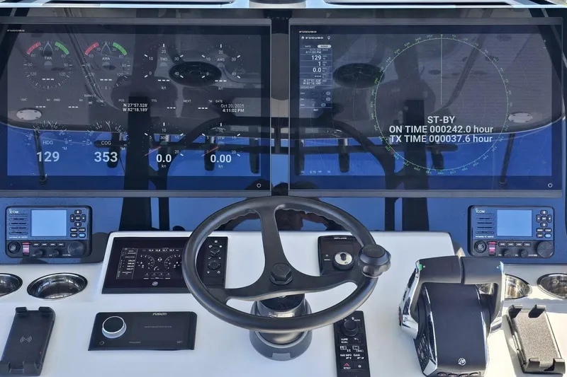Slide: The Image of Cockpit of 2025 Costa Custom Boats 34ST with advanced navigation displays and controls. - 29