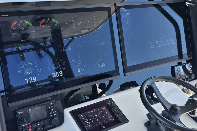 Slide: The Image of Helm of 2025 Costa Custom Boats 34ST with advanced navigation displays and controls. - 30