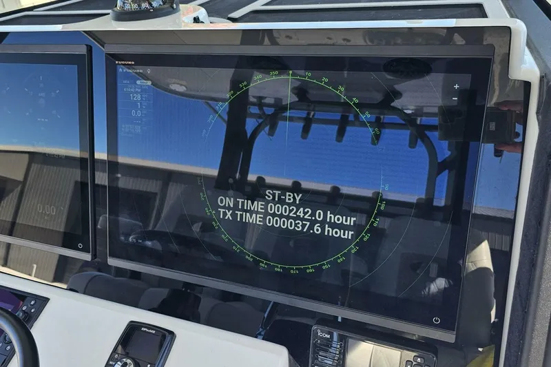 Slide: The Image of 2025 Costa Custom Boats 34ST dashboard with radar display and operational hours. - 31