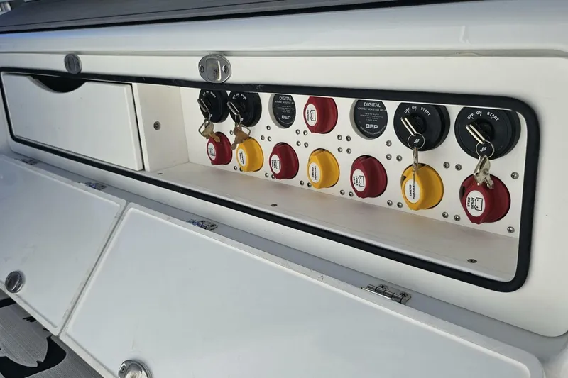 Slide: The Image of Control panel of 2025 Costa Custom Boats 34ST with switches and keys. - 36