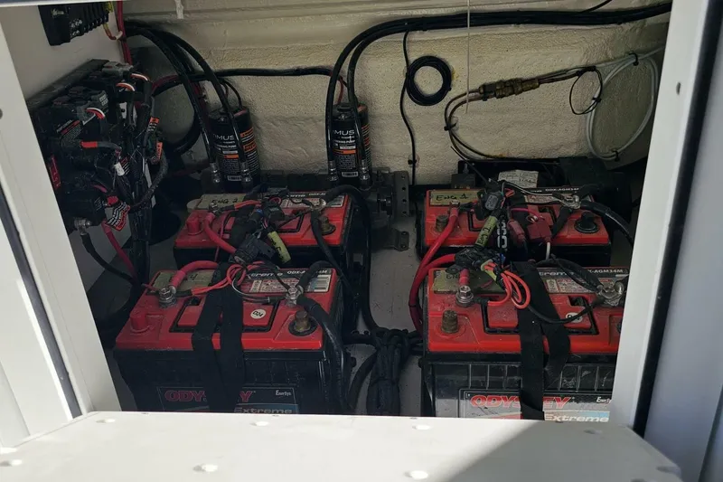 Slide: The Image of Battery compartment of 2025 Costa Custom Boats 34ST, featuring Odyssey Extreme batteries and wiring. - 39