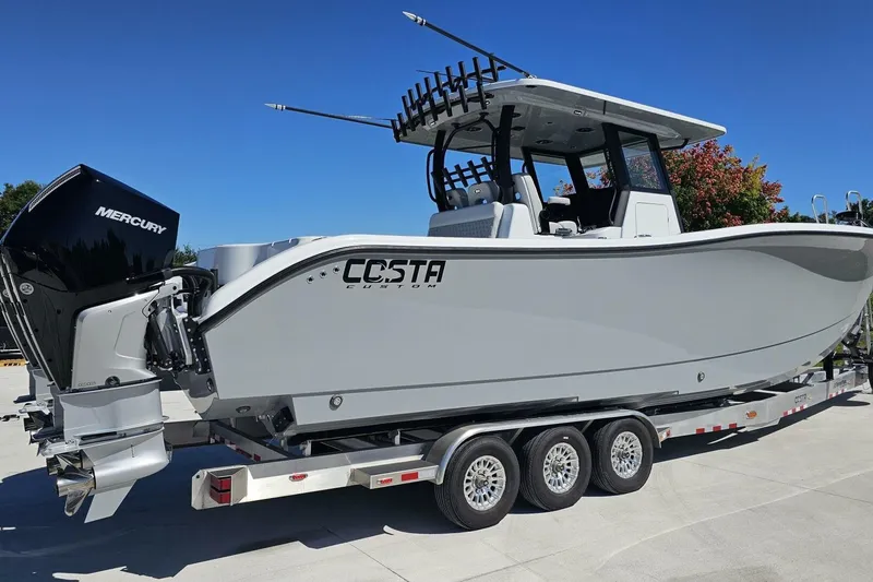 Slide: The Image of 2025 Costa Custom Boats 34ST on trailer with Mercury engines, side view. - 4