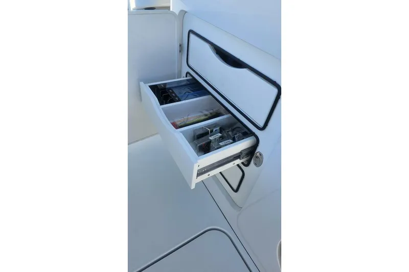 Slide: The Image of Open storage drawer on 2025 Costa Custom Boats 34ST, showcasing organized compartments. - 43