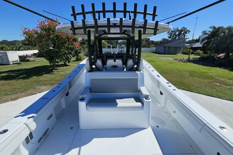 Slide: The Image of 2025 Costa Custom Boats 34ST, spacious deck with seating, rod holders, and sleek design. - 49