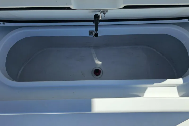 Slide: The Image of Open storage compartment on 2025 Costa Custom Boats 34ST model. - 52