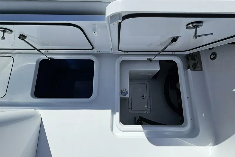 Slide: The Image of Open storage compartments on a 2025 Costa Custom Boats 34ST. - 54