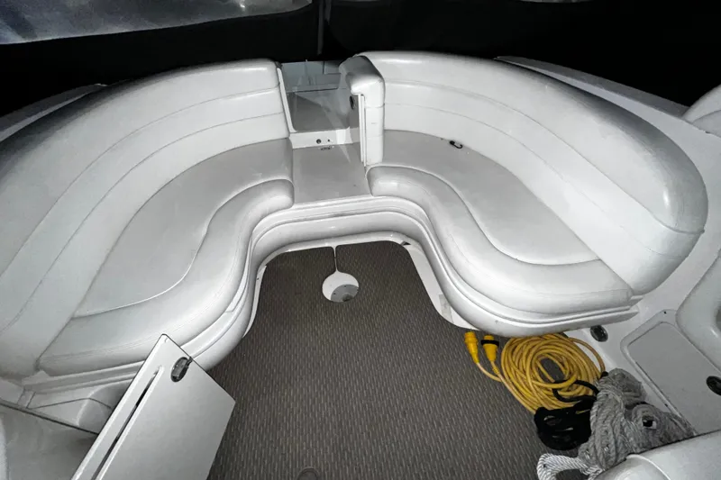 Slide: The Image of 2004 Sea Ray 290 Bowrider interior with white seating and coiled ropes. - 10