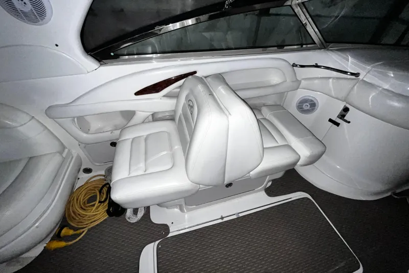 Slide: The Image of 2004 Sea Ray 290 Bowrider interior with white seating and dashboard details. - 11