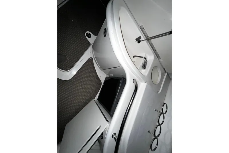 Slide: The Image of Interior view of a 2004 Sea Ray 290 Bowrider boat, featuring a compact sink area. - 13