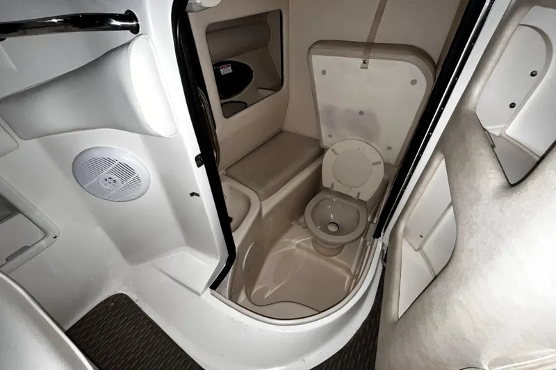 Slide: The Image of 2004 Sea Ray 290 Bowrider interior bathroom with toilet and speaker. - 19
