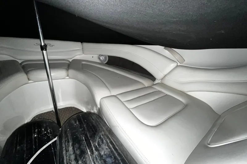 Slide: The Image of 2004 Sea Ray 290 Bowrider interior with white leather seating and sleek design. - 21