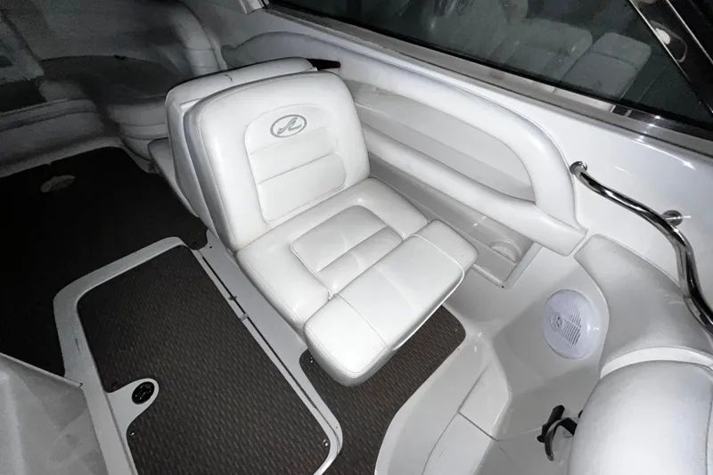 Slide: The Image of 2004 Sea Ray 290 Bowrider interior with white leather seating and sleek design. - 24