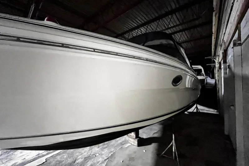 Slide: The Image of 2004 Sea Ray 290 Bowrider boat stored indoors, side view. - 25