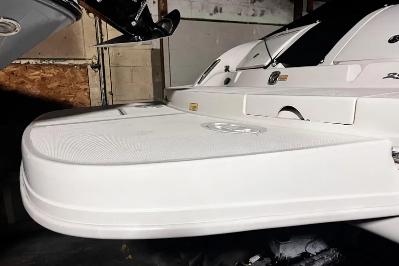 Slide: The Image of 2004 Sea Ray 290 Bowrider boat stern view in a garage setting. - 4