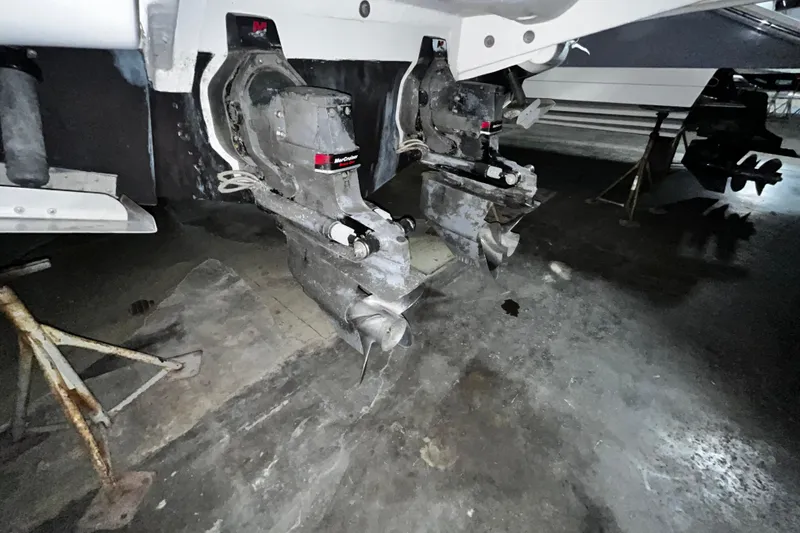 Slide: The Image of 2004 Sea Ray 290 Bowrider boat with dual MerCruiser outdrives in a garage. - 6