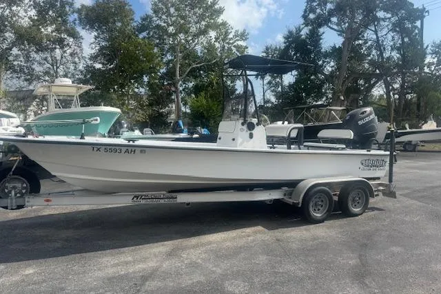 Slide: The Image of 2007 Haynie 23 Bigfoot boat on trailer, parked outdoors with trees in background. - 11