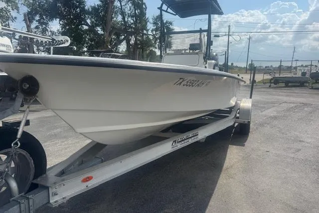 Slide: The Image of 2007 Haynie 23 Bigfoot boat on trailer, parked outdoors under a sunny sky. - 12